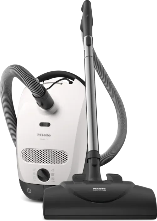 White and black Miele canister vacuum cleaner with hose, wand, and floor brush.