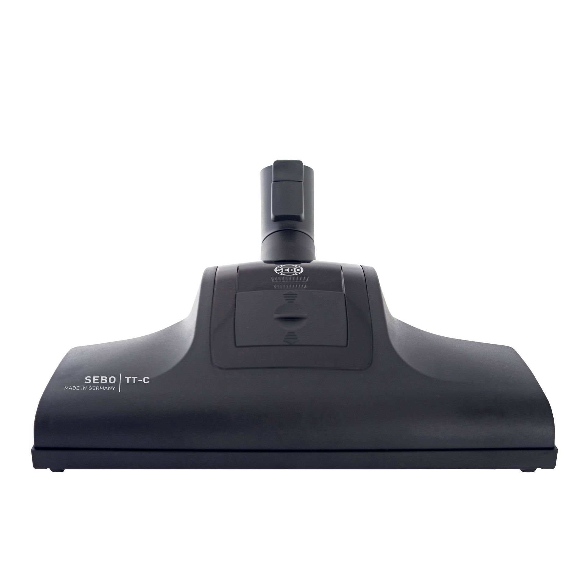 Black vacuum cleaner head with a central connector and a rounded rectangular shape.