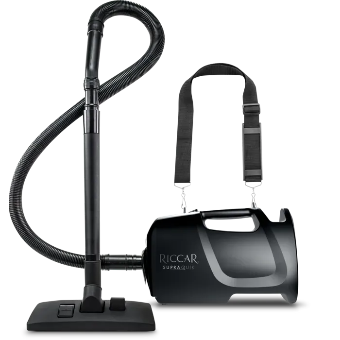 Black RioCar Ultra vacuum cleaner with a carrying strap and hose.