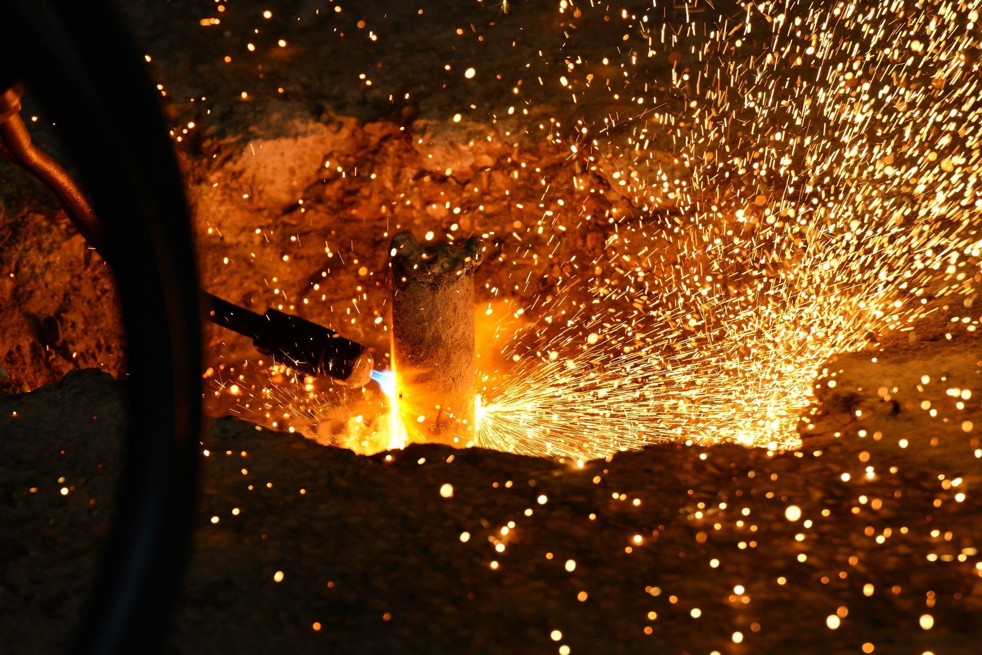 Welder cutting the steel rod using a high-temperature gas cutter. Welder cutting the steel rod using a high-temperature gas cutter.