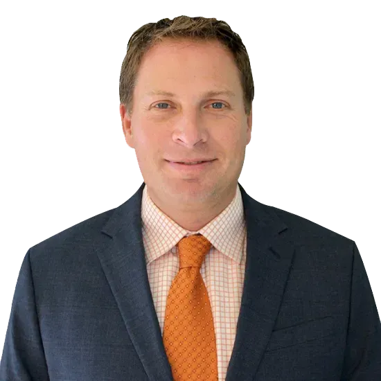 A man in a suit and tie is smiling for the camera