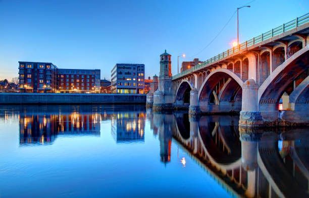 A bridge over a body of water with buildings in the background.