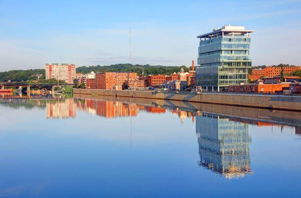 A city skyline is reflected in a body of water.
