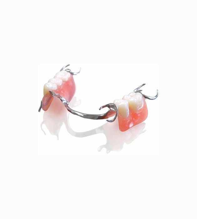 Close Up of a Partial Denture on a White Surface — Cosmetic Denture Services–Jacob Maxwell in Mackay, QLD