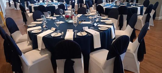 Round banquet tables set with navy and white linens in a formal event hall