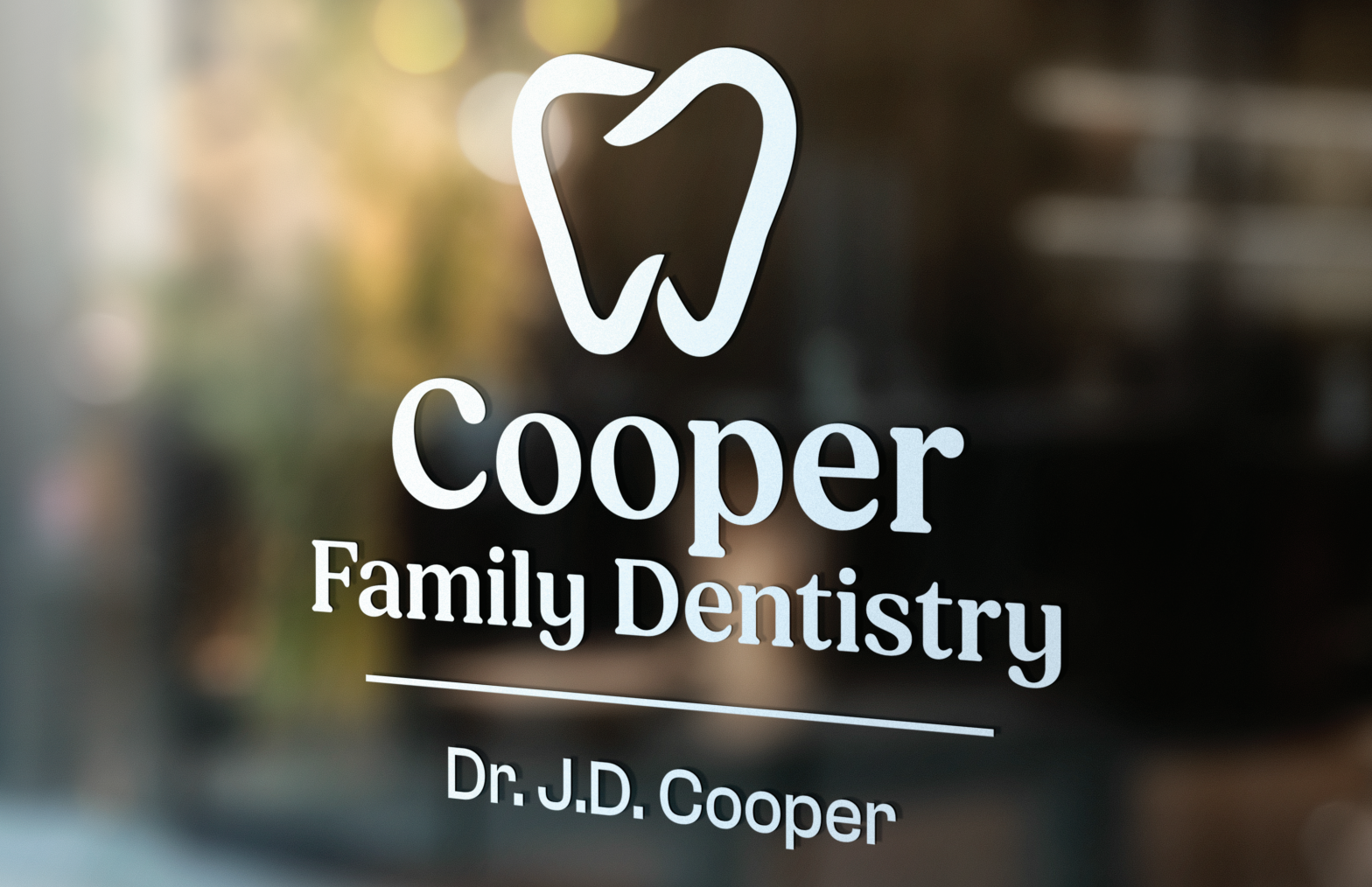 Cooper Family Dentistry logo on a glass door with a white tooth icon and Dr. J.D. Cooper text