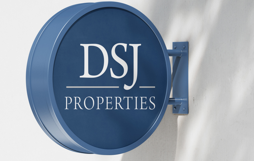 Round blue DSJ Properties sign mounted on a wall