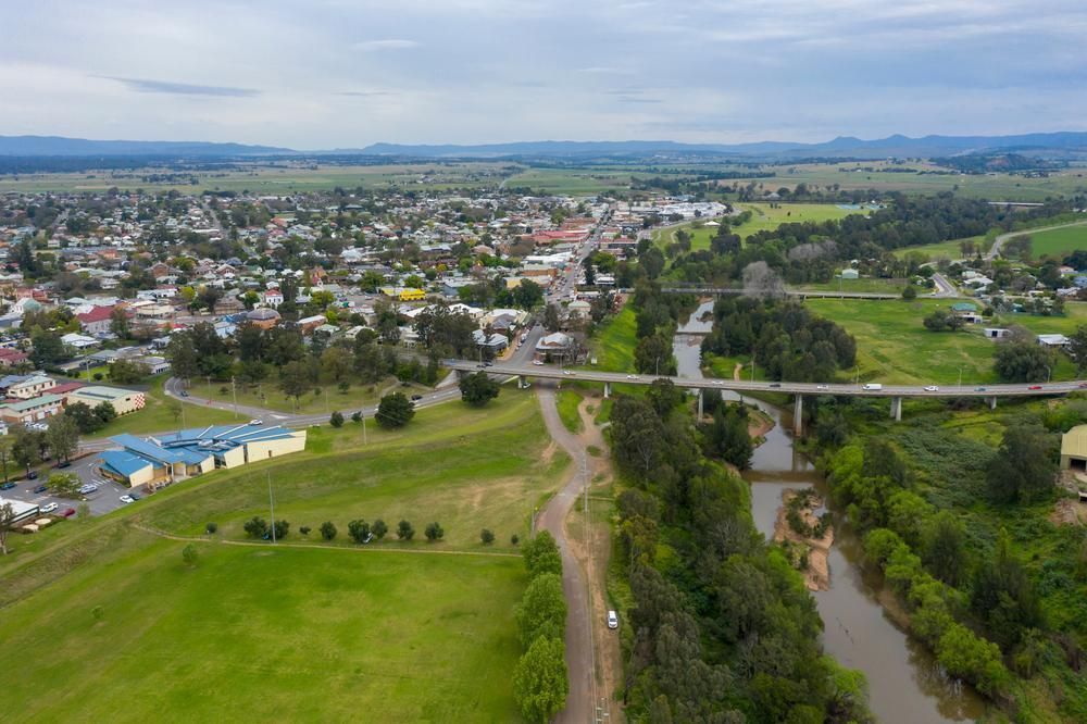 an Aerial View of a Small Town Next to a River and a Bridge — Port Stephens Bathrooms In New Lambton, NSW
