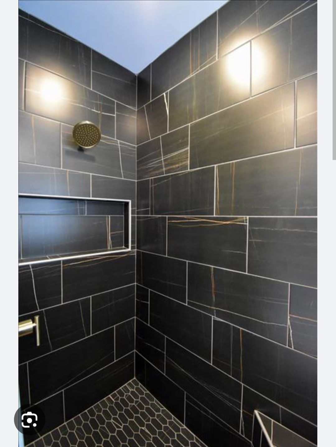 Modern black-tiled shower with rain showerhead and small frosted window niche