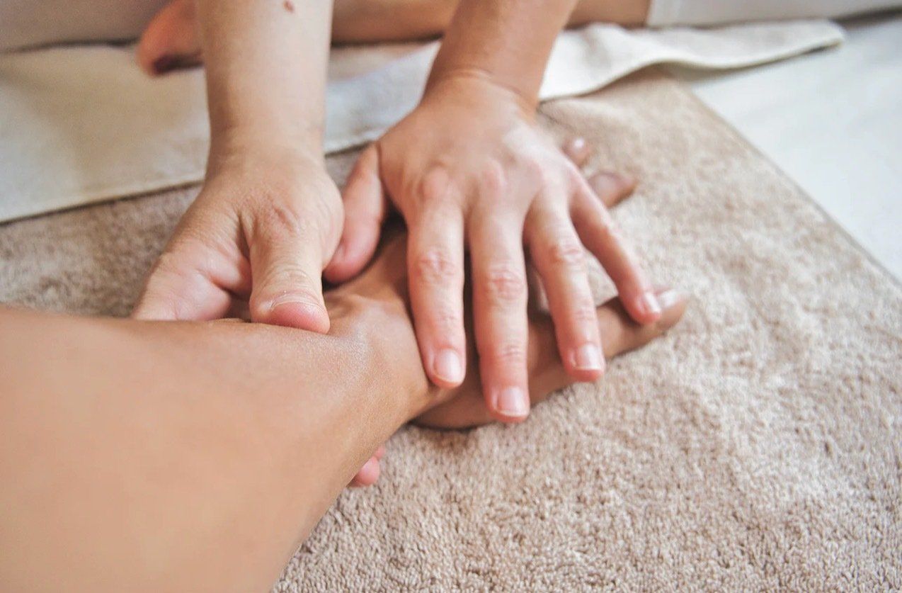 A person is getting a foot massage from another person.