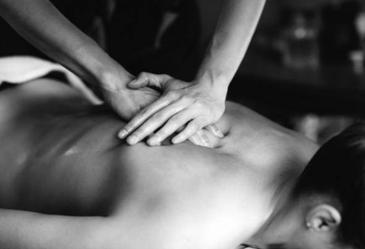 Massage therapist giving back massage.