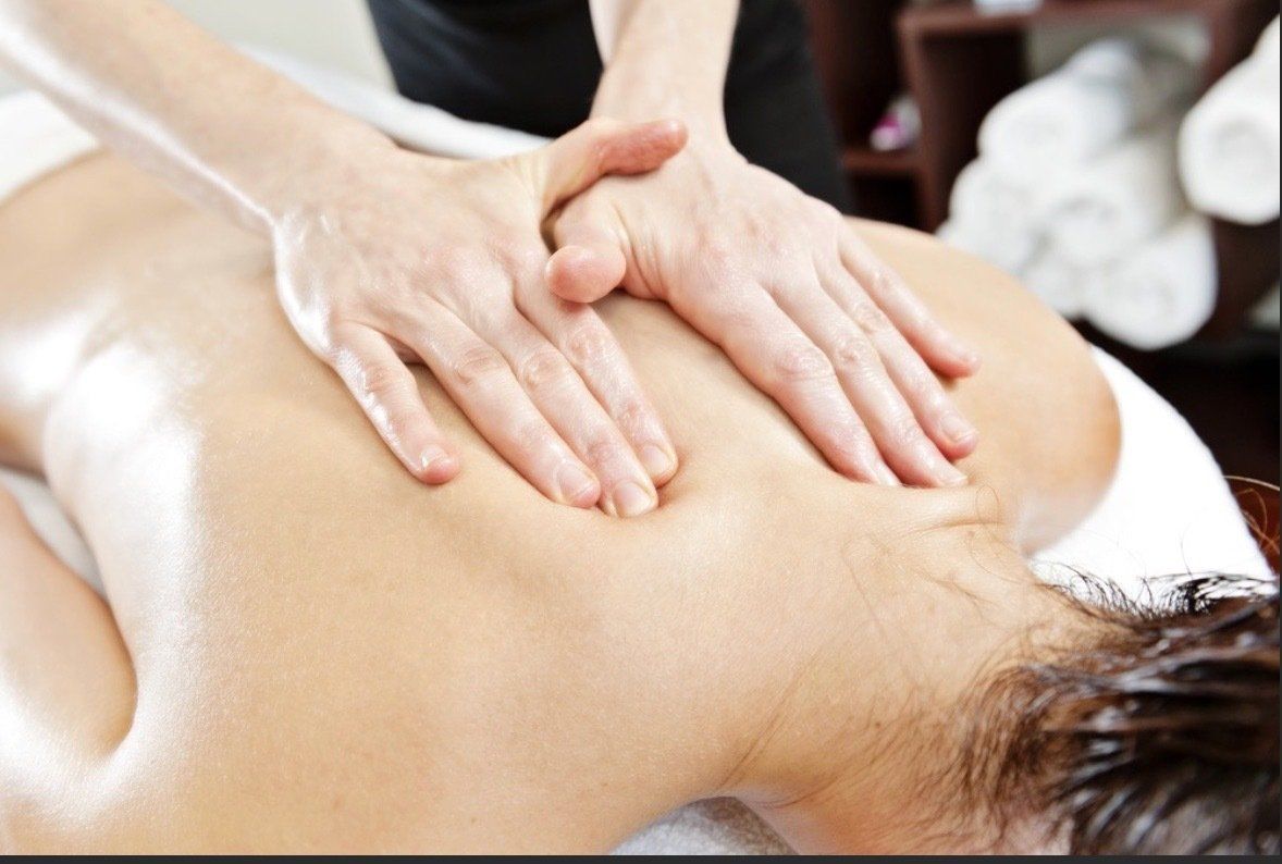 A woman is getting a massage on her back