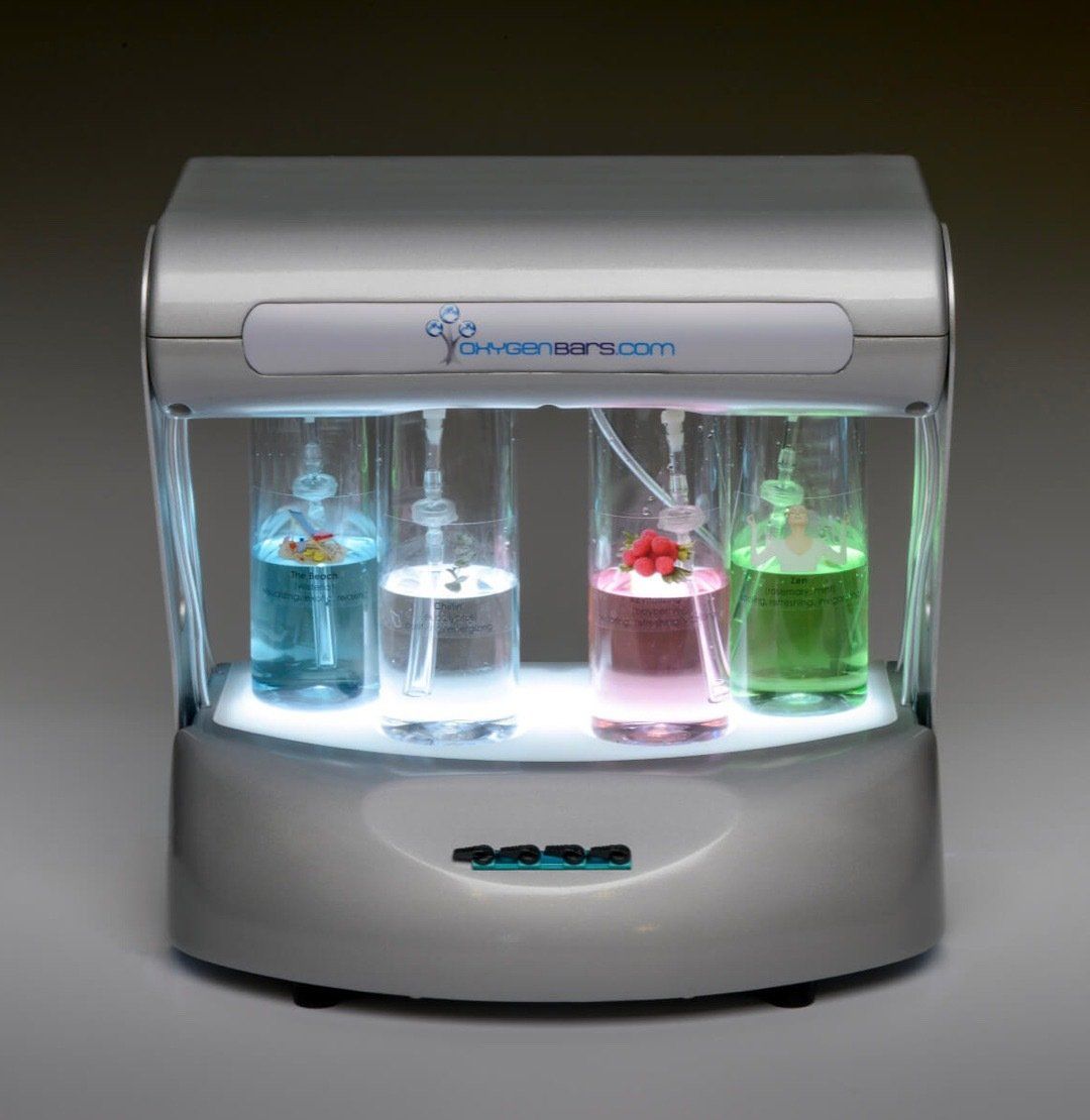 A machine with four bottles of liquid inside of it