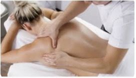 A woman is getting a massage from a man in a white shirt.
