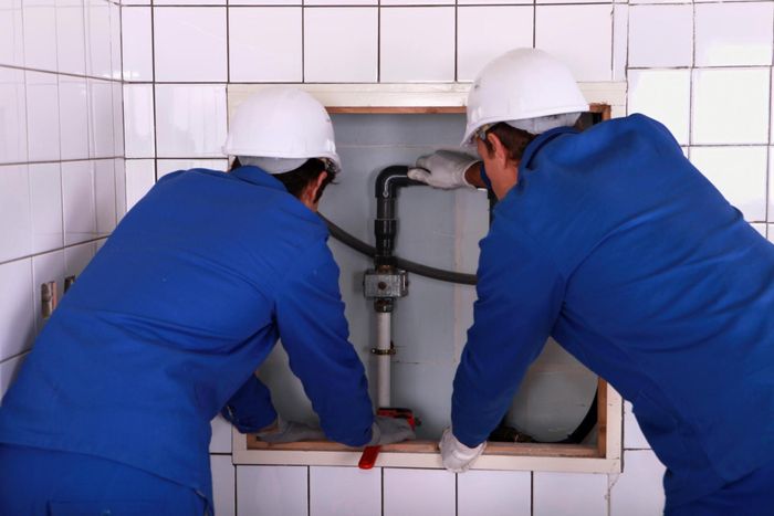 workers are checking the pipes
