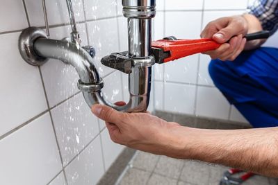 plumber fixing the leak pipe