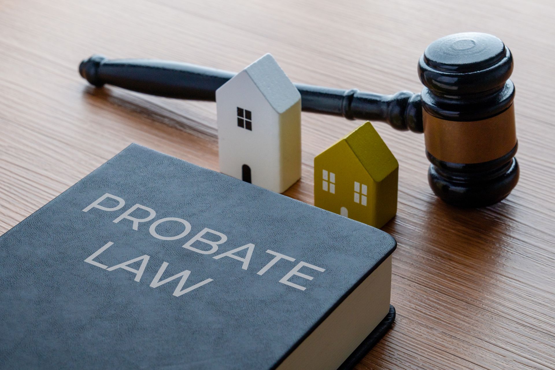 Miniature houses, judge's gavel and a PROBATE LAW book.