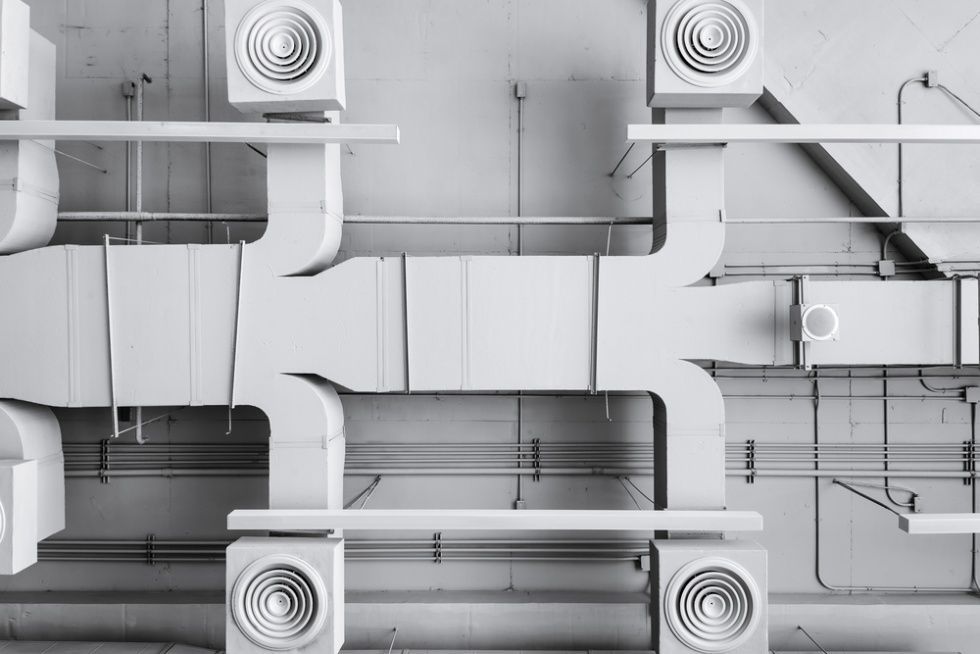 A Ceiling With A Lot Of White Pipes And Fans On It — Cool & Secure In Maroochydore, QLD