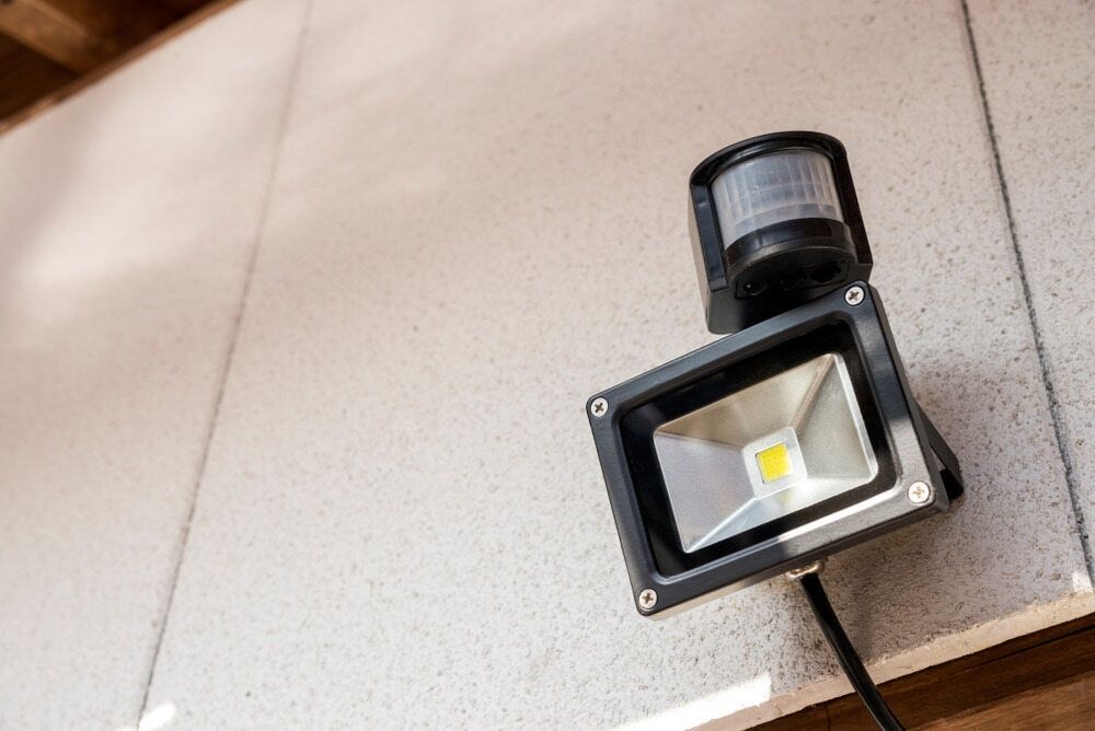 A Close Up Of A Flood Light With A Motion Sensor Attached To It — Cool & Secure In Maroochydore, QLD