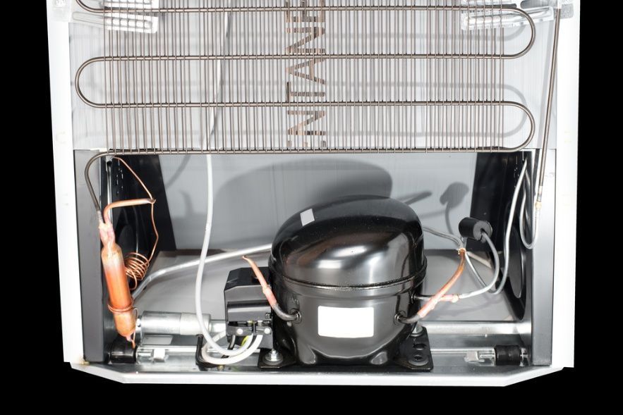 The Inside Of A Refrigerator With The Compressor Visible — Cool & Secure In Noosa, QLD