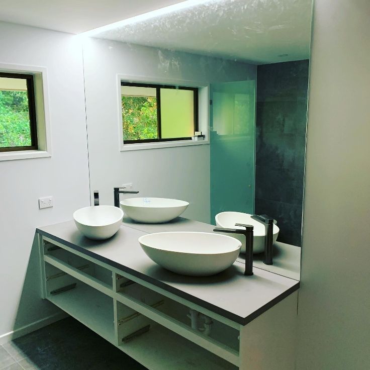A Bathroom With Two Sinks And A Large Mirror — Cool & Secure In Warana, QLD