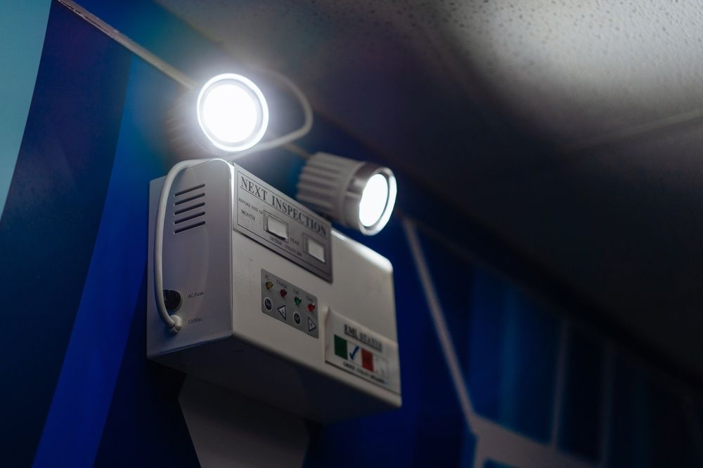 A Emergency Light Is Hanging From The Ceiling In A Room — Cool & Secure In Noosa, QLD
