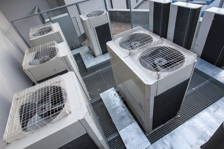 A Bunch Of Air Conditioners Are Sitting On Top Of A Building — Cool & Secure In Maroochydore, QLD