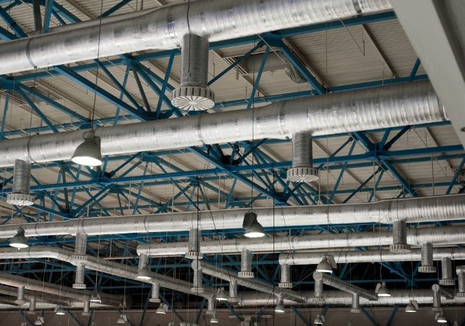 There Are A Lot Of Pipes Hanging From The Ceiling Of A Building — Cool & Secure In Noosa, QLD