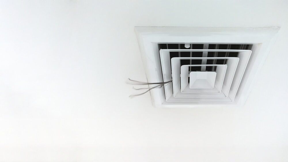 A White Air Vent Is Hanging From The Ceiling Of A Room — Cool & Secure In Buderim, QLD