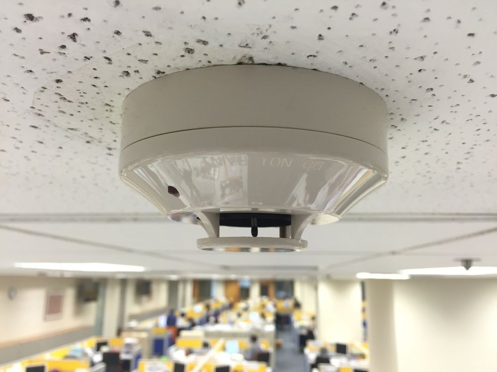A Smoke Detector Is Mounted To The Ceiling In An Office — Cool & Secure In Buderim, QLD