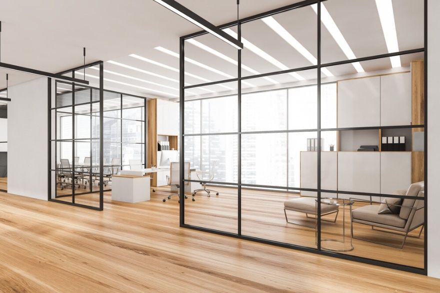 A Modern Office With A Lot Of Glass Walls And Wooden Floors — Cool & Secure In Maroochydore, QLD