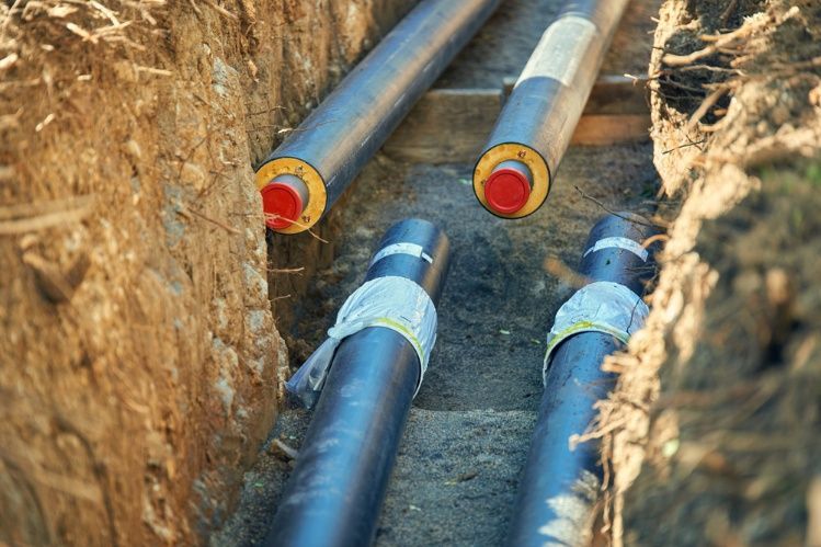A Bunch Of Pipes Are Being Installed In A Trench — Cool & Secure In Buderim, QLD