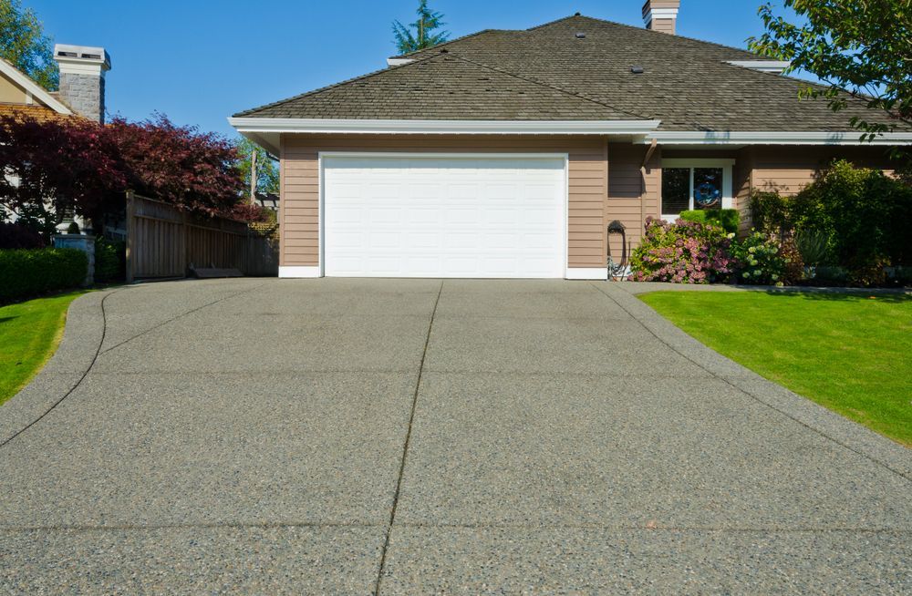 Suburban House With A White Garage Door And A Concrete Driveway — Lennox Build In Lennox Head, NSW