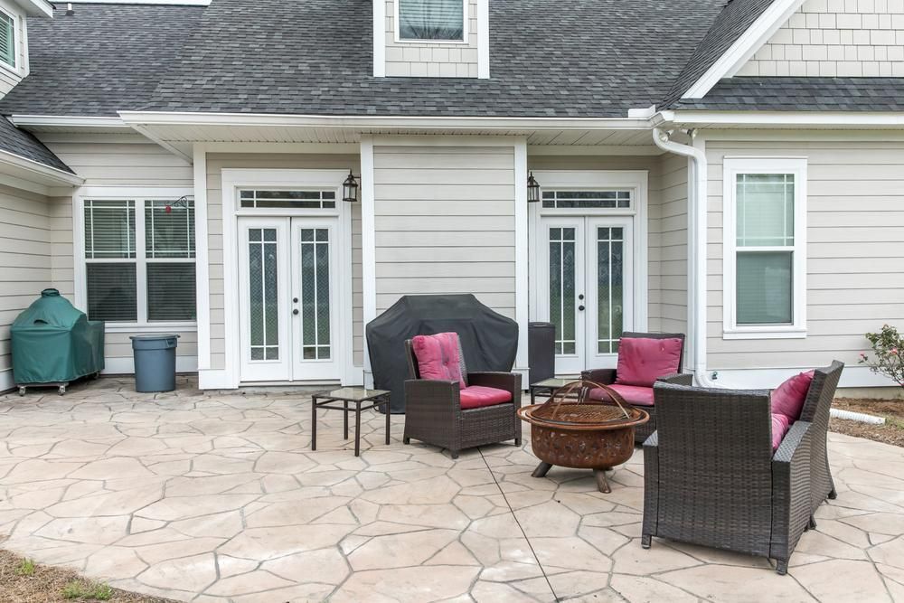 A Patio With Furniture and a Fire Pit in Front of a House — Lennox Build In Lennox Head, NSW