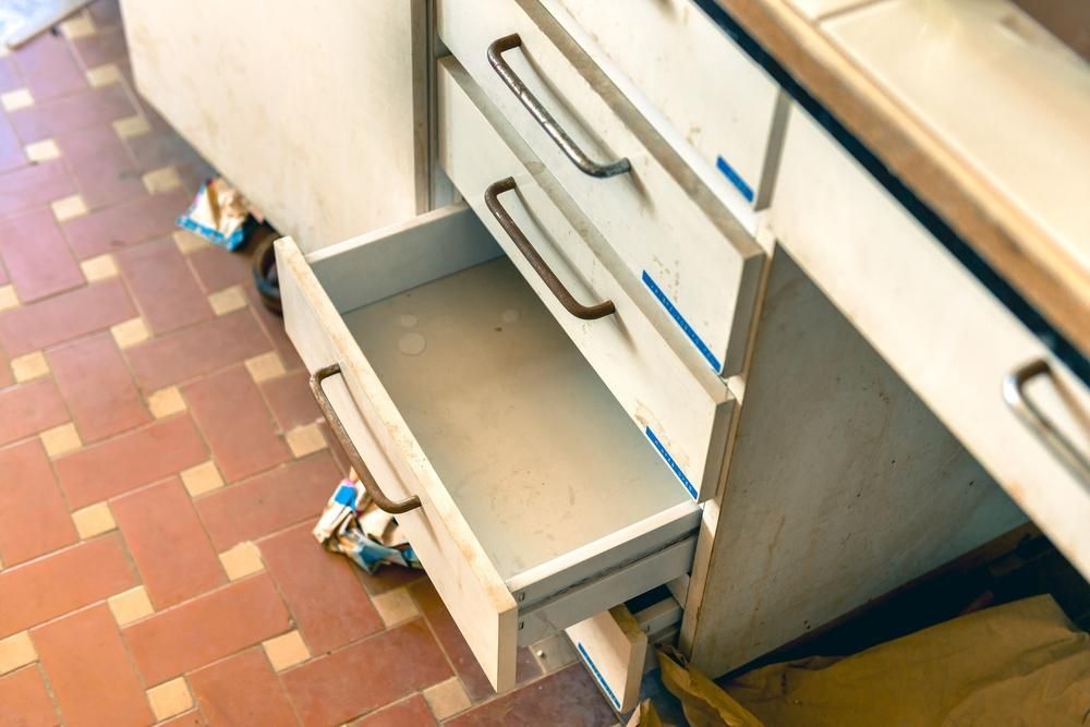 An Empty Drawer in a Kitchen With a Tiled Floor — Lennox Build In Lismore, NSW