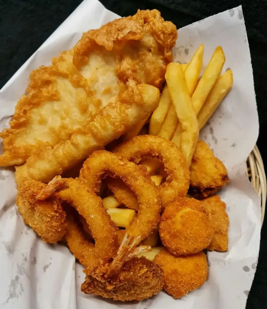 A Basket of Fried Fish, Golden-Brown French Fries, Breaded Shrimp — Sav's Takeaway In Mount Isa, QLD