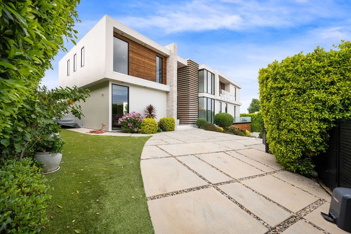 A modern house with a driveway leading to it