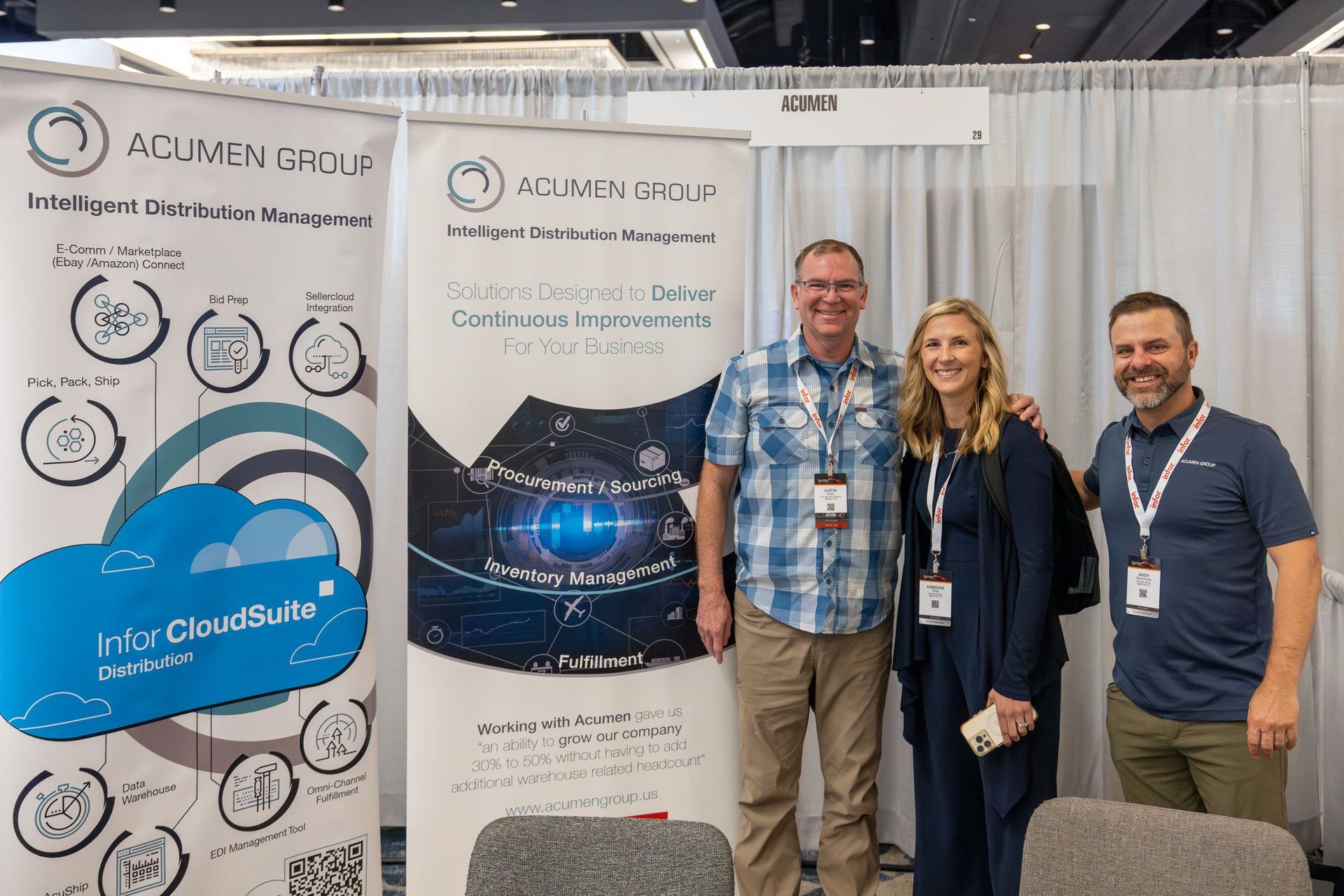 Three people pose in front of a conference booth with the 