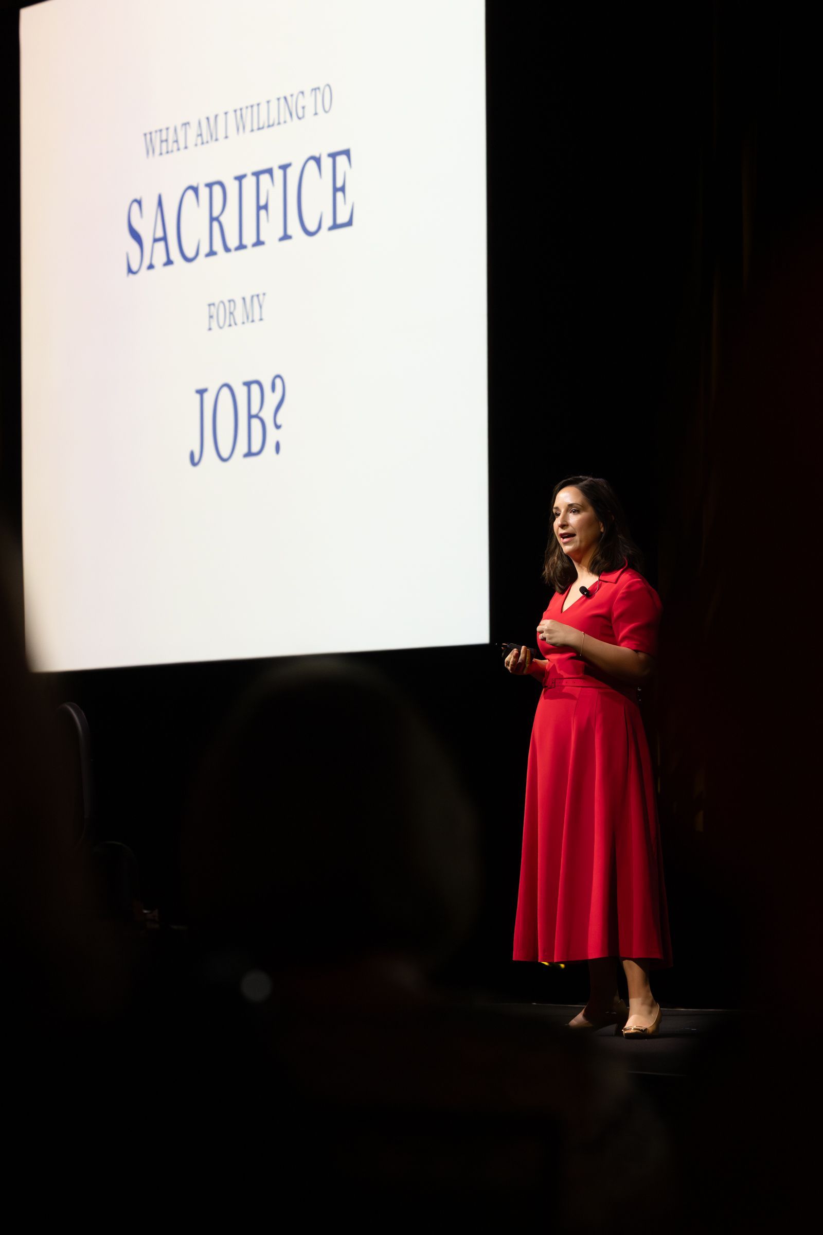 Woman in red dress giving presentation on 