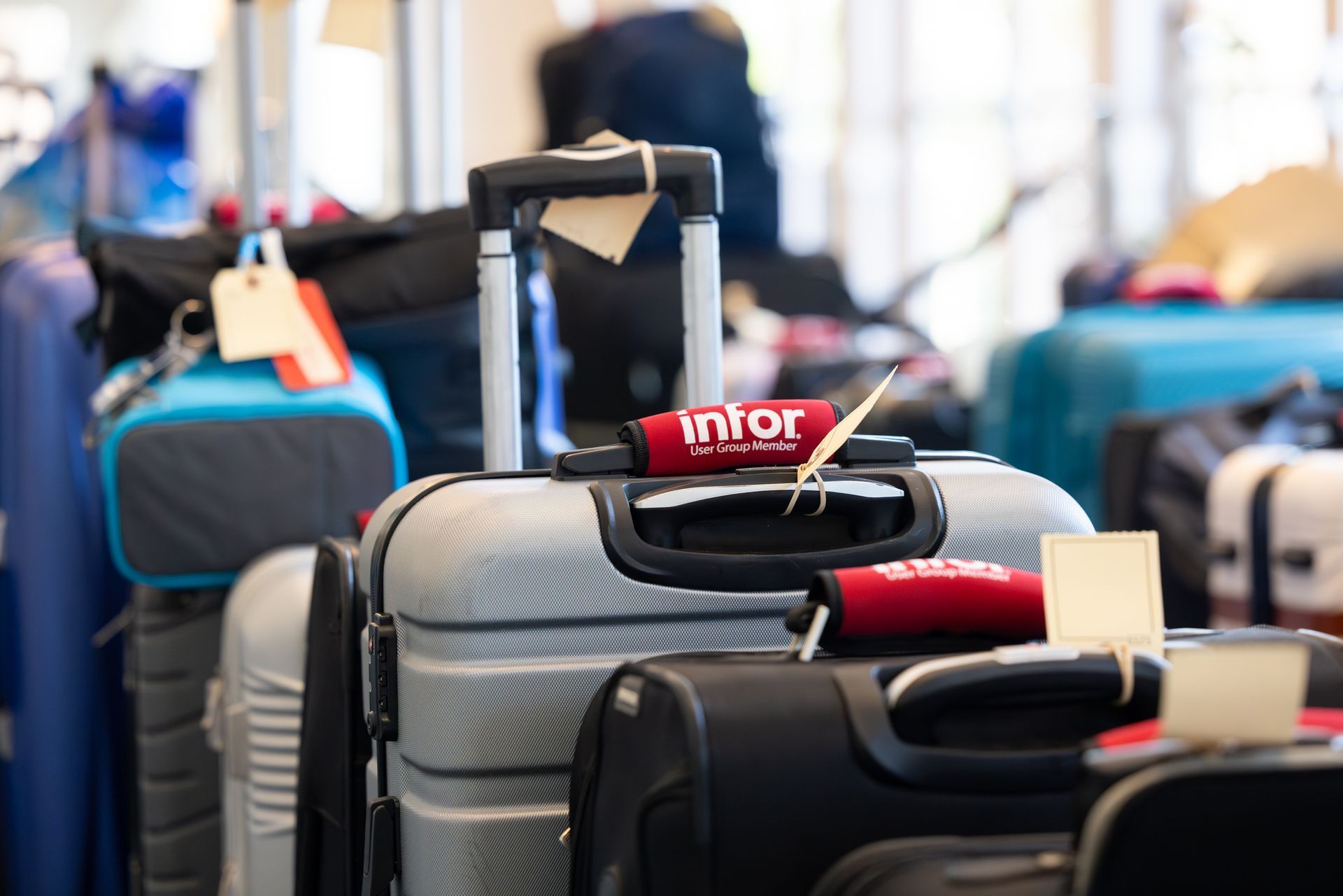 Luggage on a baggage carousel at an airport, some with tags, and an 