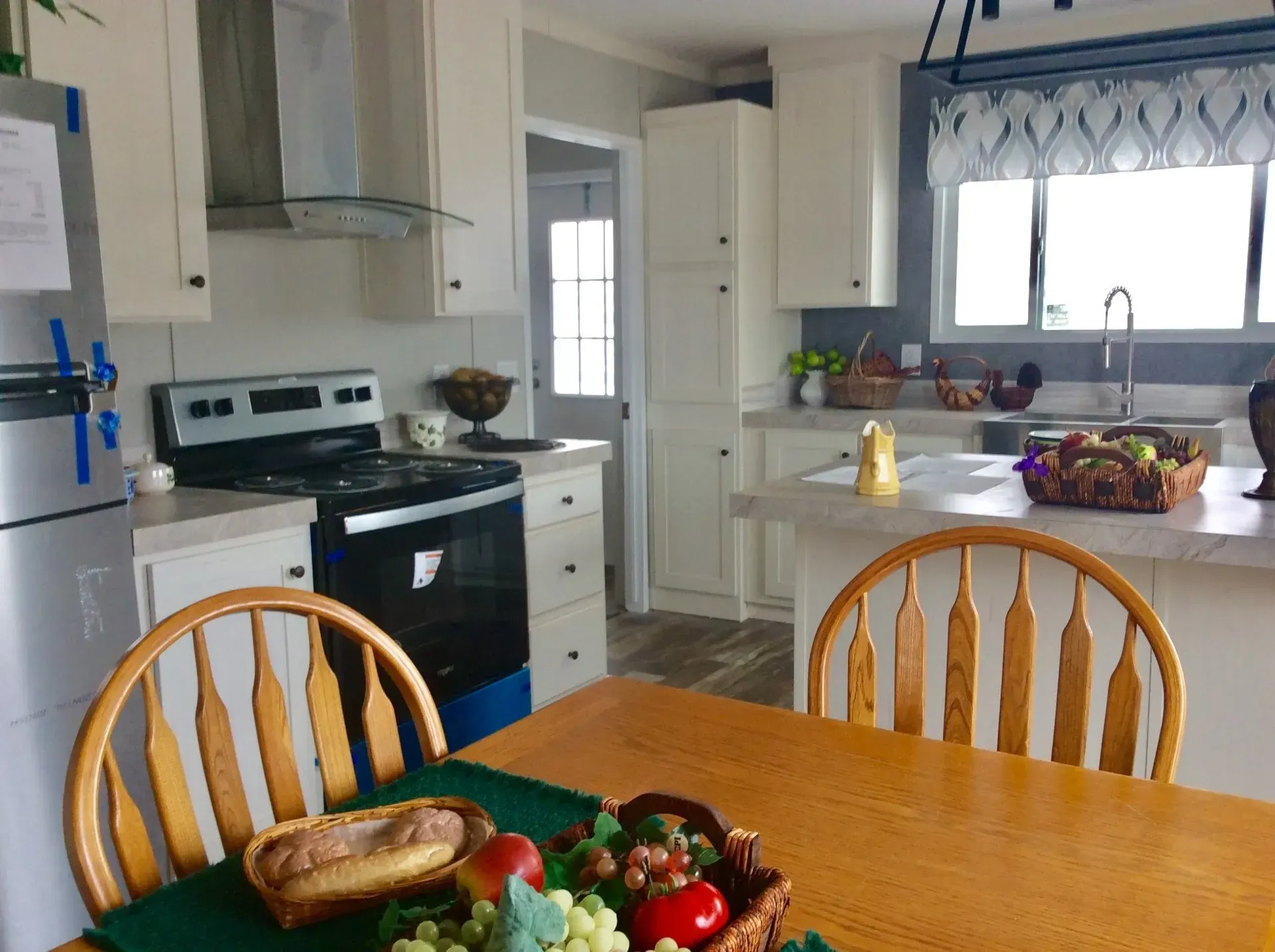 A kitchen with a table and chairs and a stove
