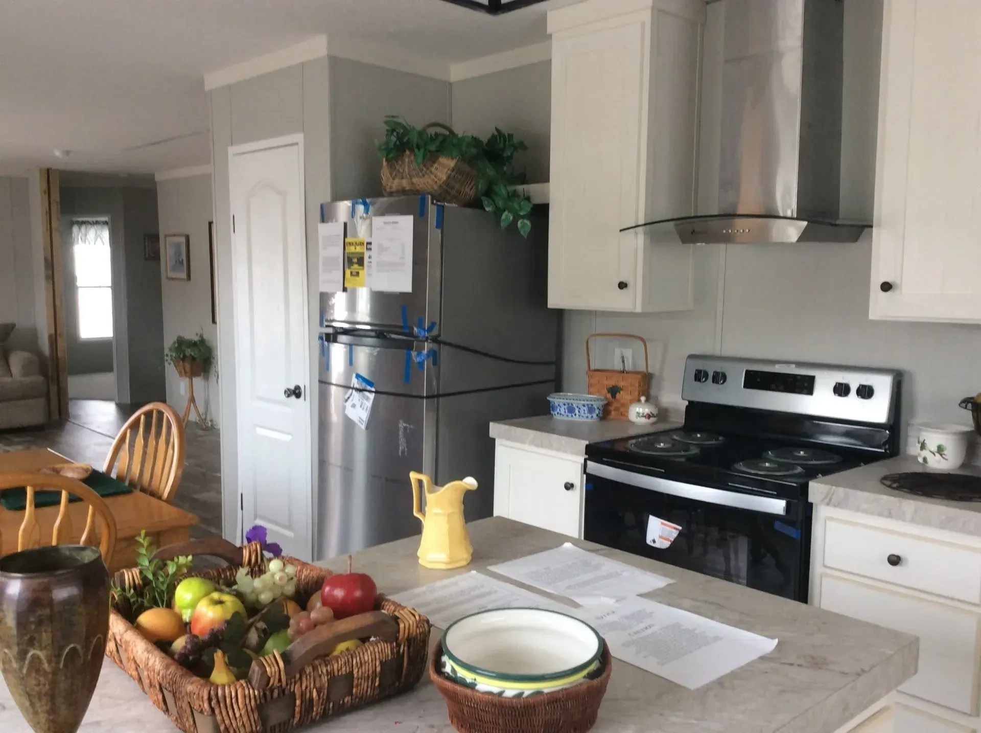 A kitchen with a stainless steel refrigerator , stove , and sink.