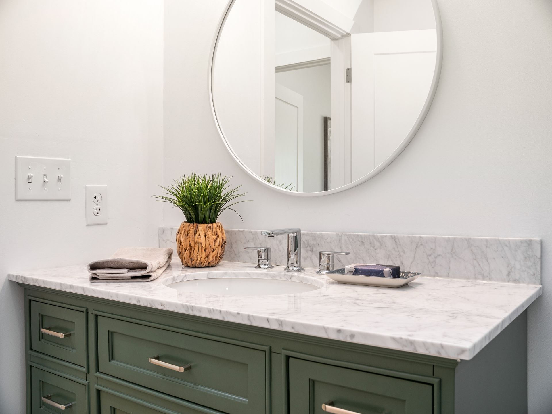 A bathroom with a sliding glass shower door