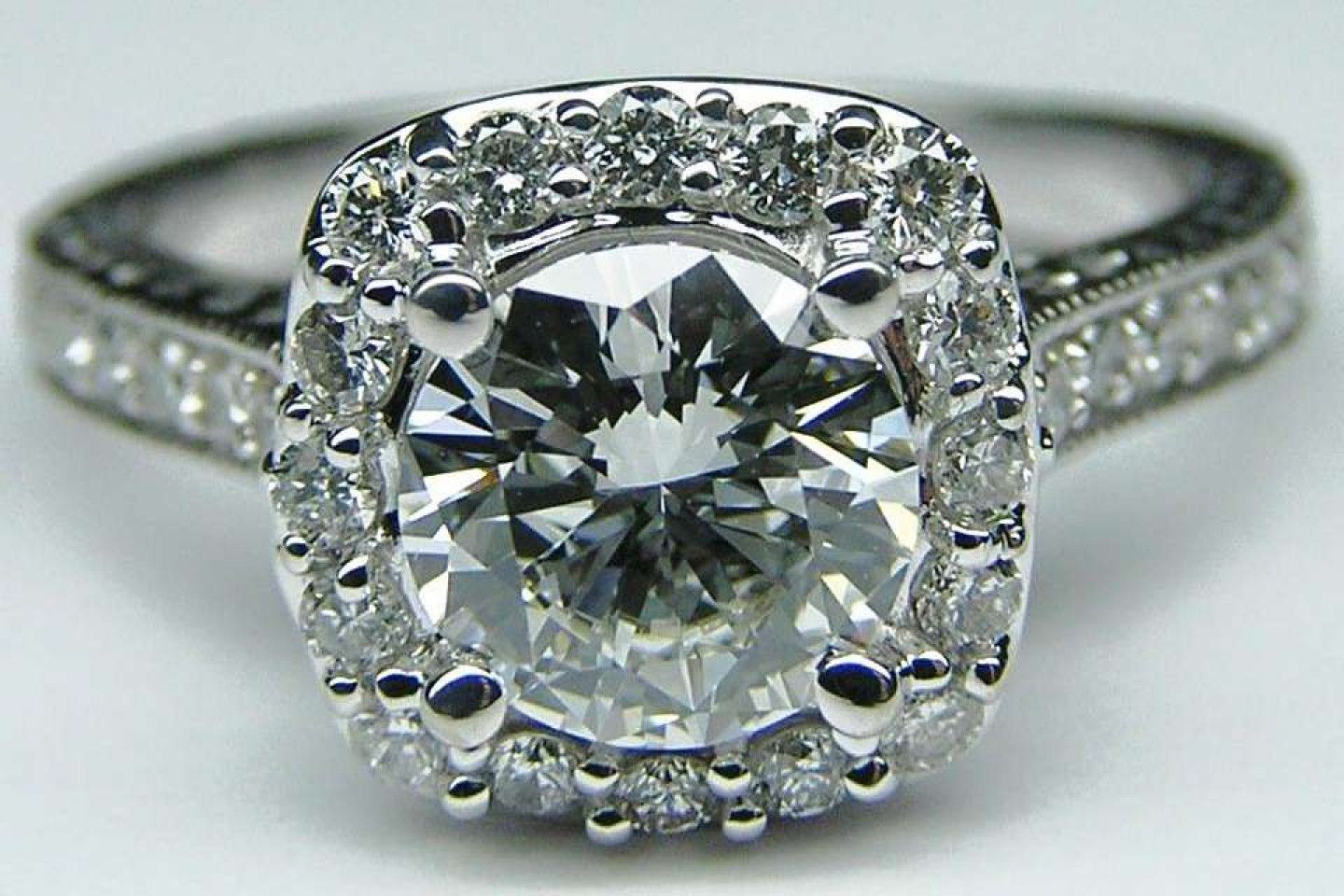 A group of diamonds are sitting on top of each other on a black surface.