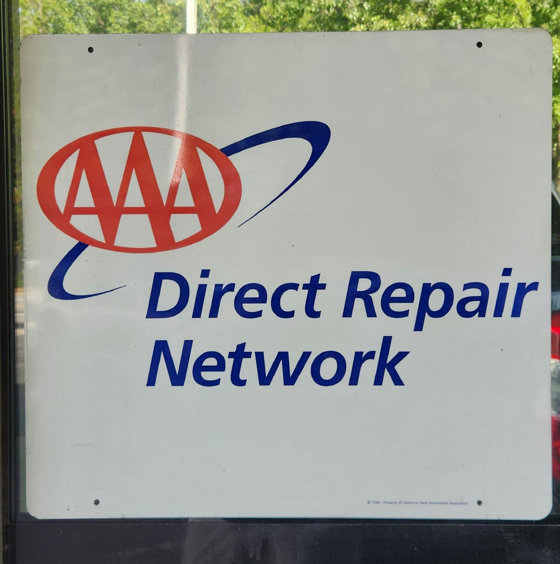 AAA Direct Repair Network sign with red and blue logo on a white background | Tripp's Auto Body