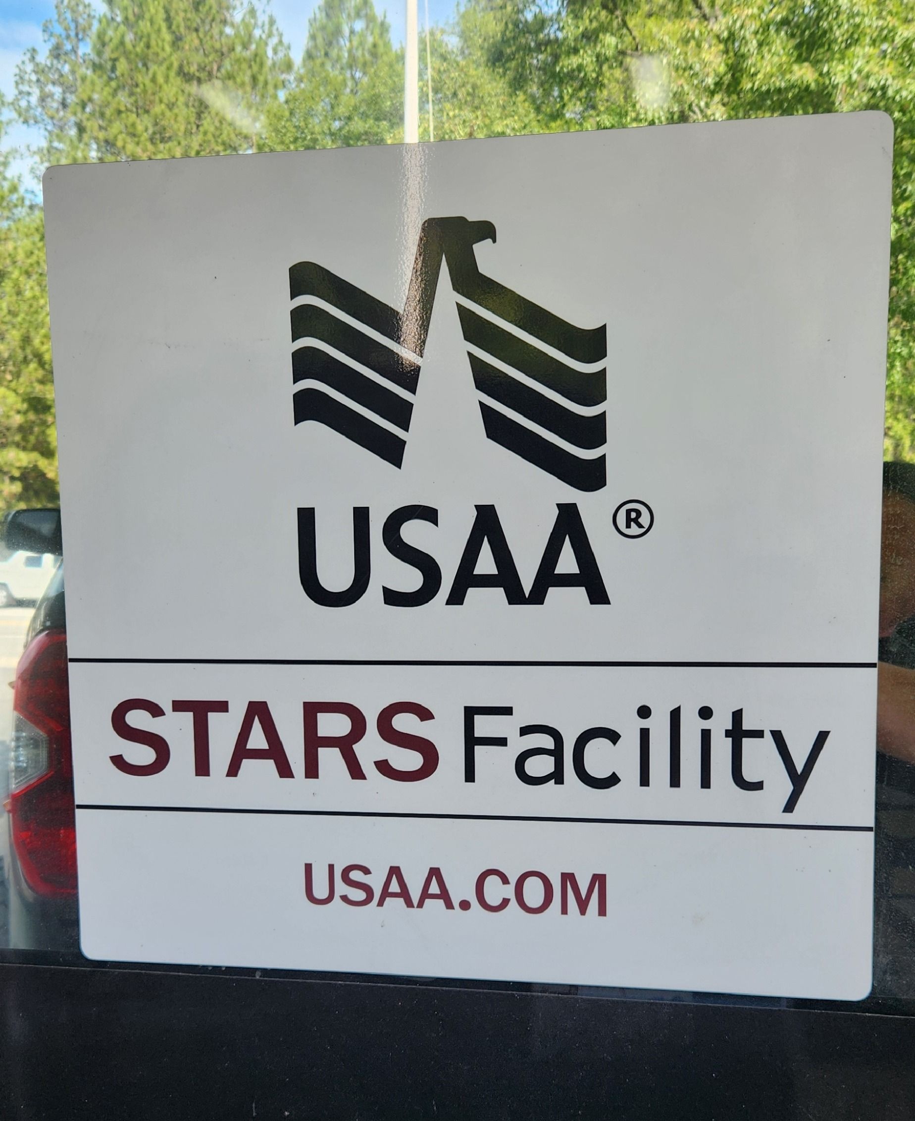 USAA STARS Facility sign with logo and USAA.com on a window display | Tripp's Auto Body