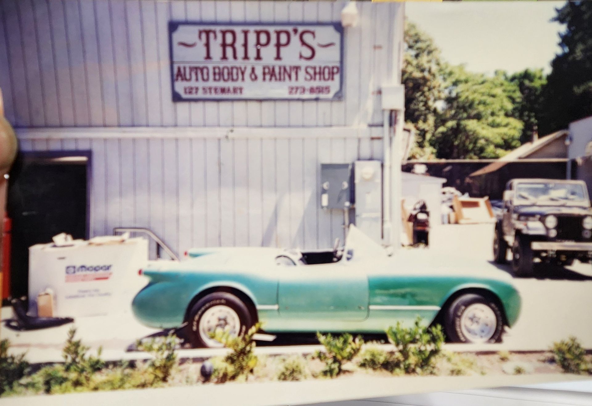 Teal convertible parked outside Tripp’s Auto Body & Paint Shop | Tripp's Auto Body