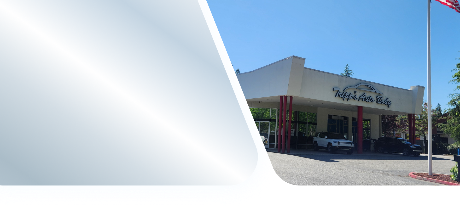 Auto repair shop with a black car on a lift and a mechanic working on a bicycle in the foreground | Tripp's Auto Body