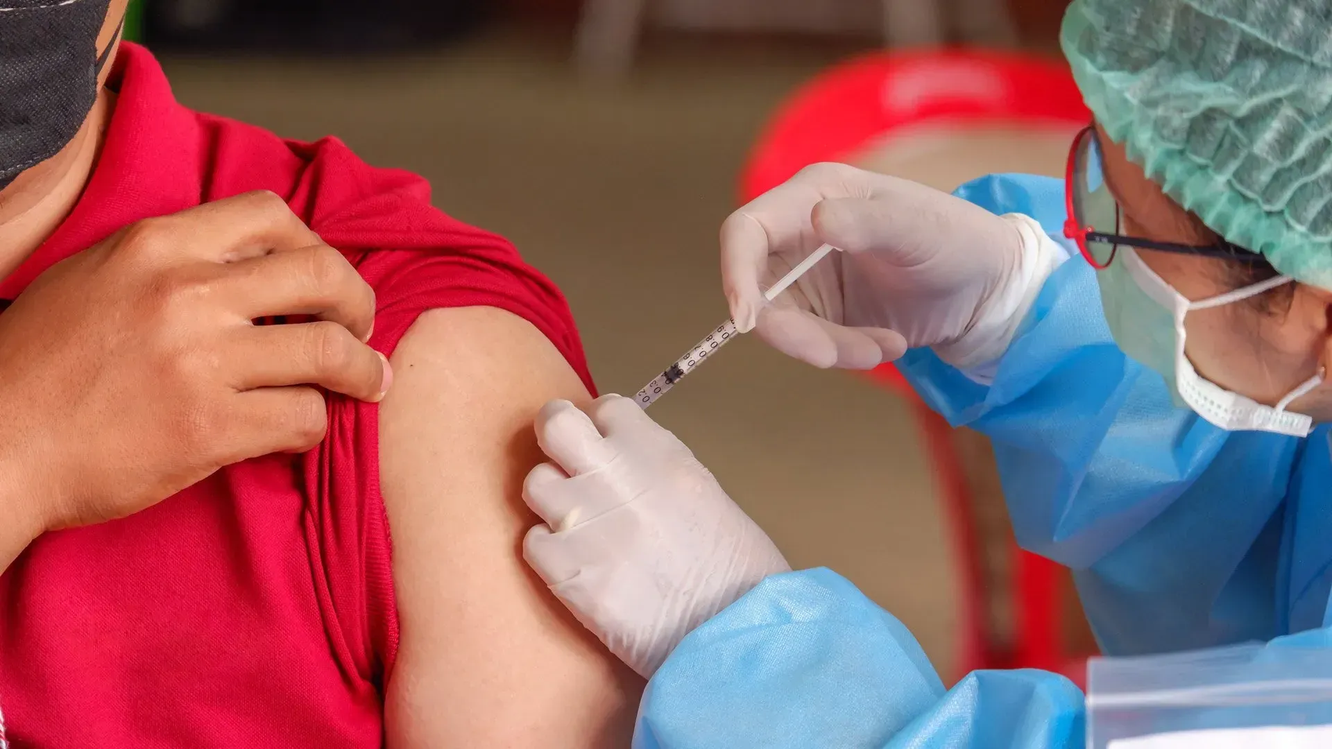 A person is getting a vaccine in their arm.