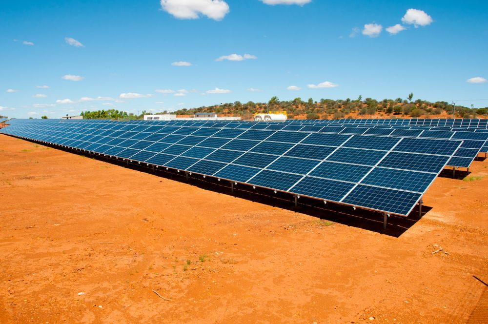 A Row of Solar Panels Sitting on Top of a Dirt Field — Burnett Home Energy Centre in Bundaberg Central, QLD